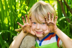 40446211 - child playing in garden with dirty hands